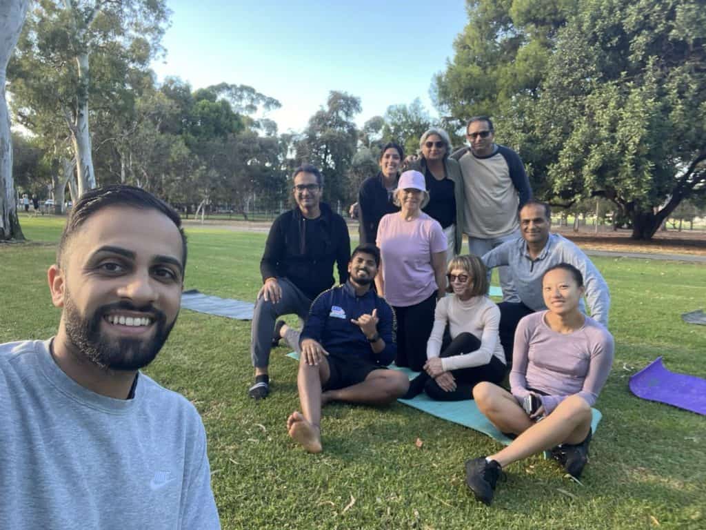 Group of people enjoying outdoor fitness session in park for Community Fun Run & Strength + Flex 202.