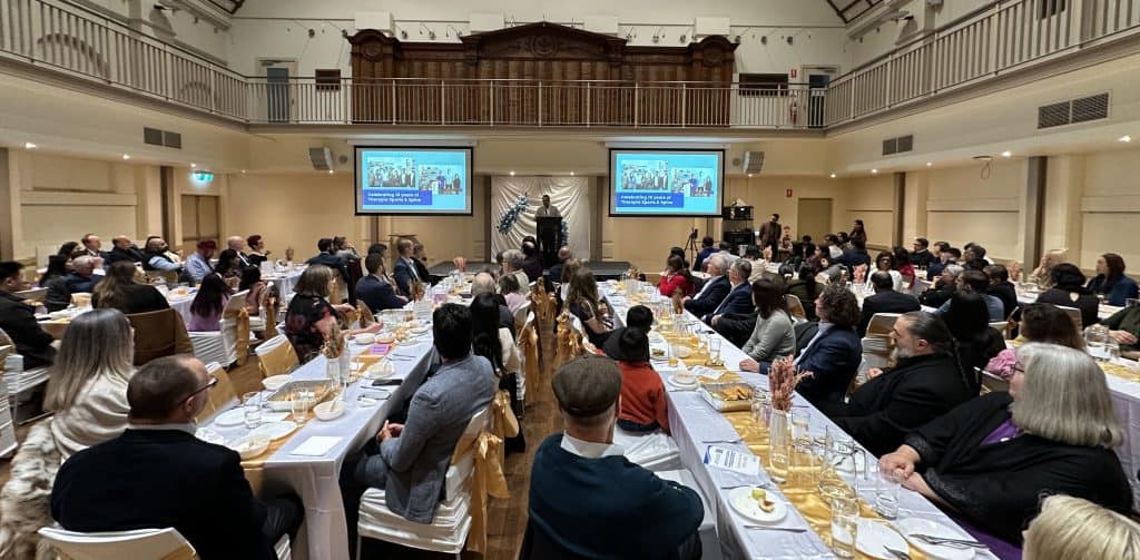 Therapia 10th Year Anniversary Celebration event with attendees in a grand hall.