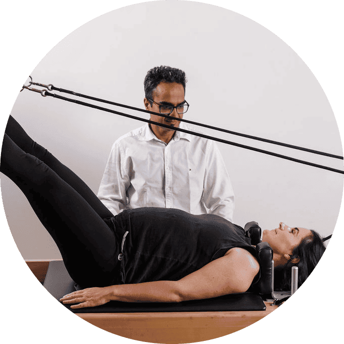 Gentle physical therapy session with a therapist using resistance bands on a patient lying on a trea.